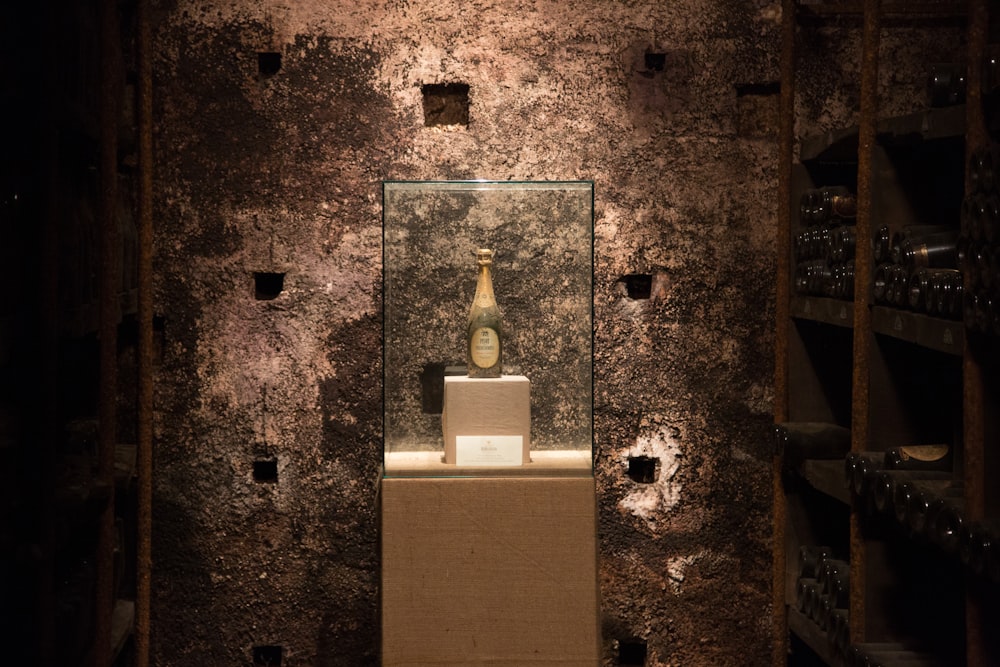 a display case with a bottle of wine in it