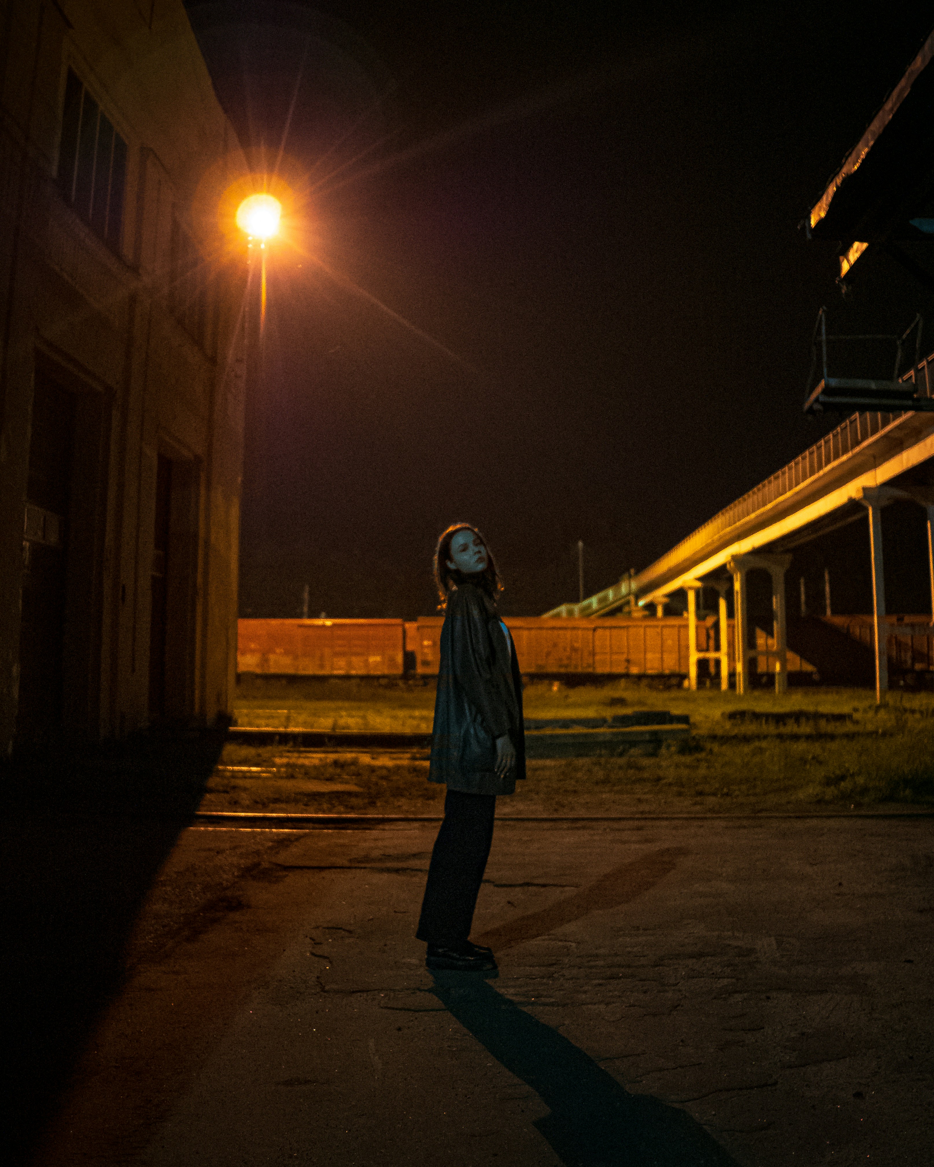 a person standing on a street at night