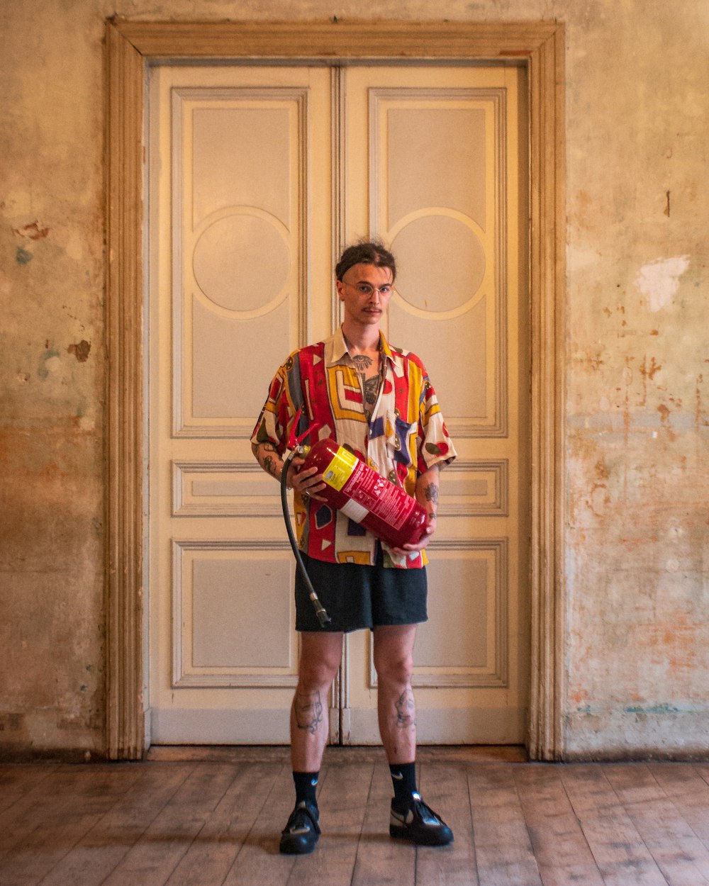 a man standing in front of a door with a hose