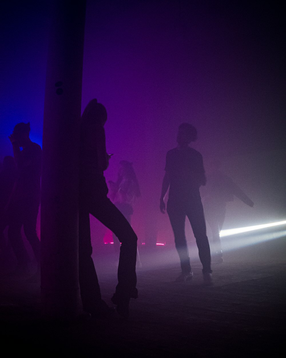 a group of people standing around in the dark