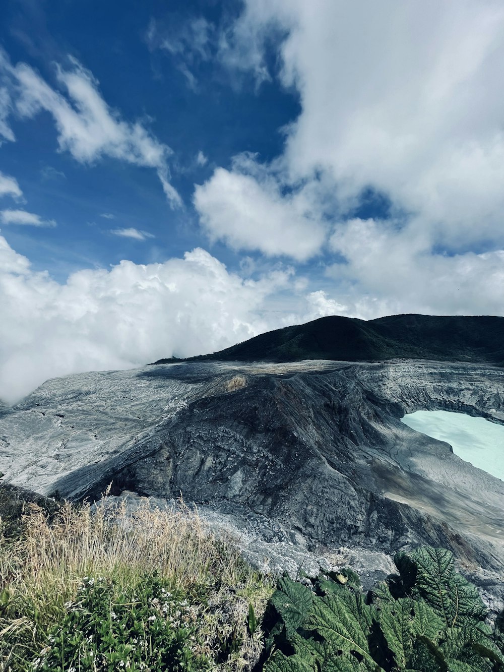 a large crater with a lake in the middle of it