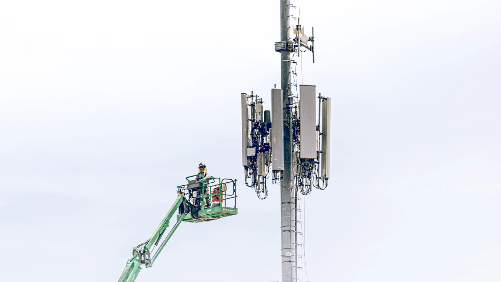 Worker in a lift servicing a cellular monopole
