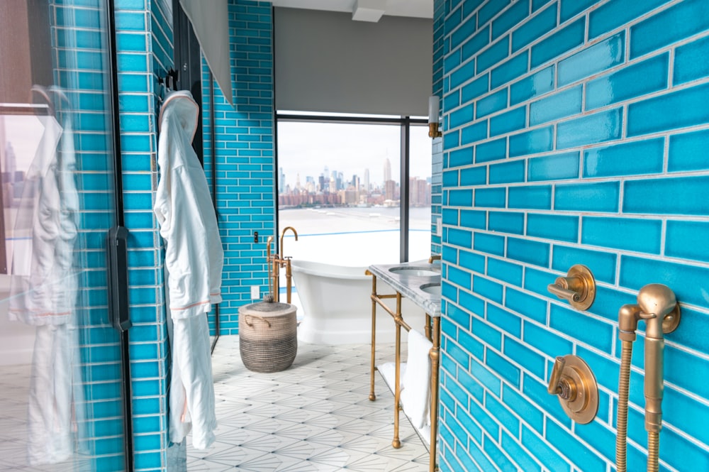 a bath room with a bath tub a sink and a window