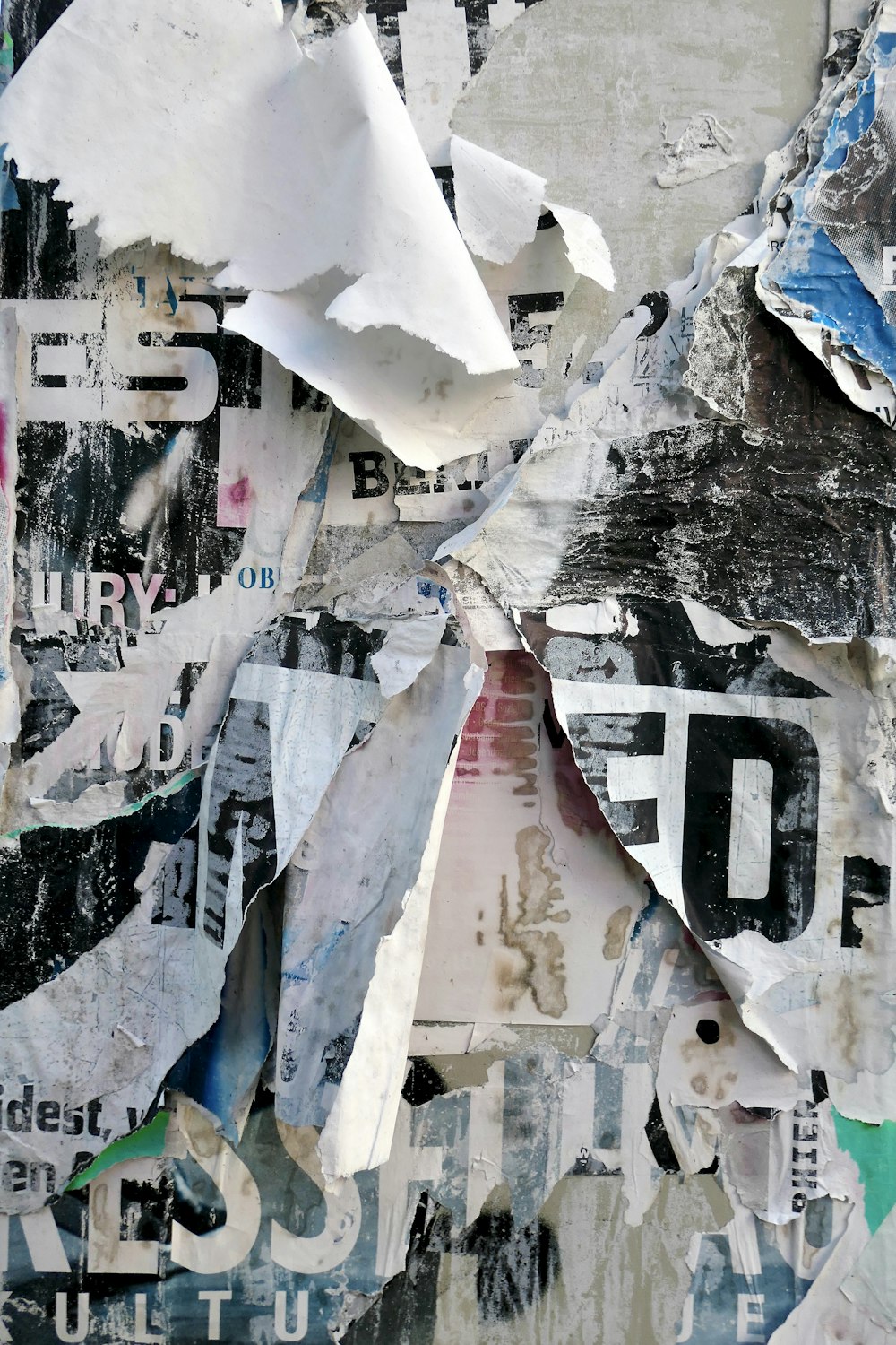 a collage of torn up papers and other items