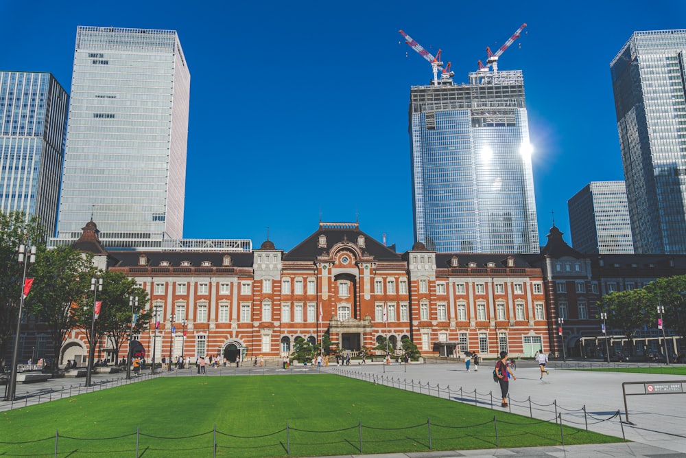 a large building with a green lawn in front of it