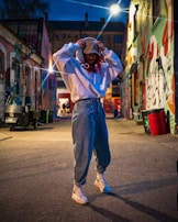 Model wearing a relaxed-fit hoodie and cargo pants walking down a city alley.