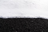 a black and white photo of snow on the ground