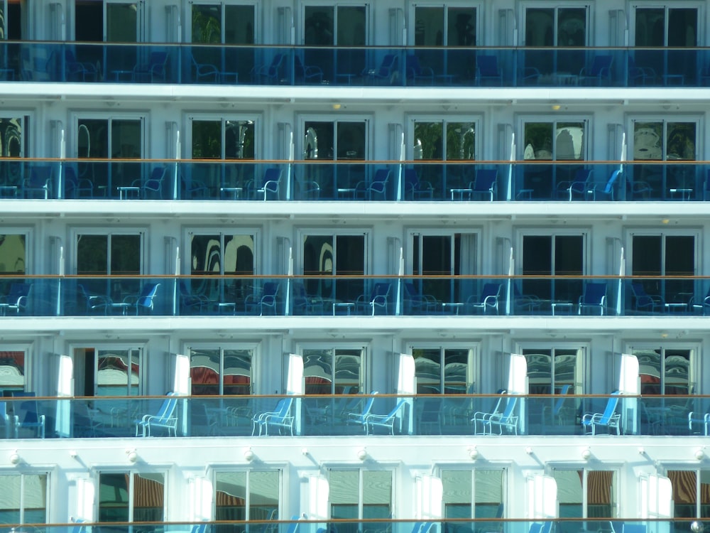 a cruise ship's balcony and balconies are reflected in the windows