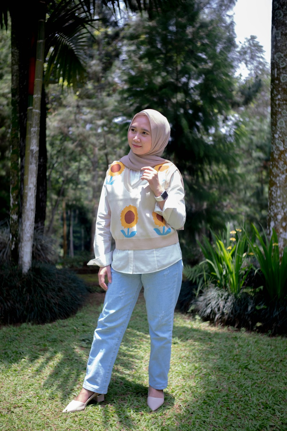 a woman standing in the grass with a frisbee