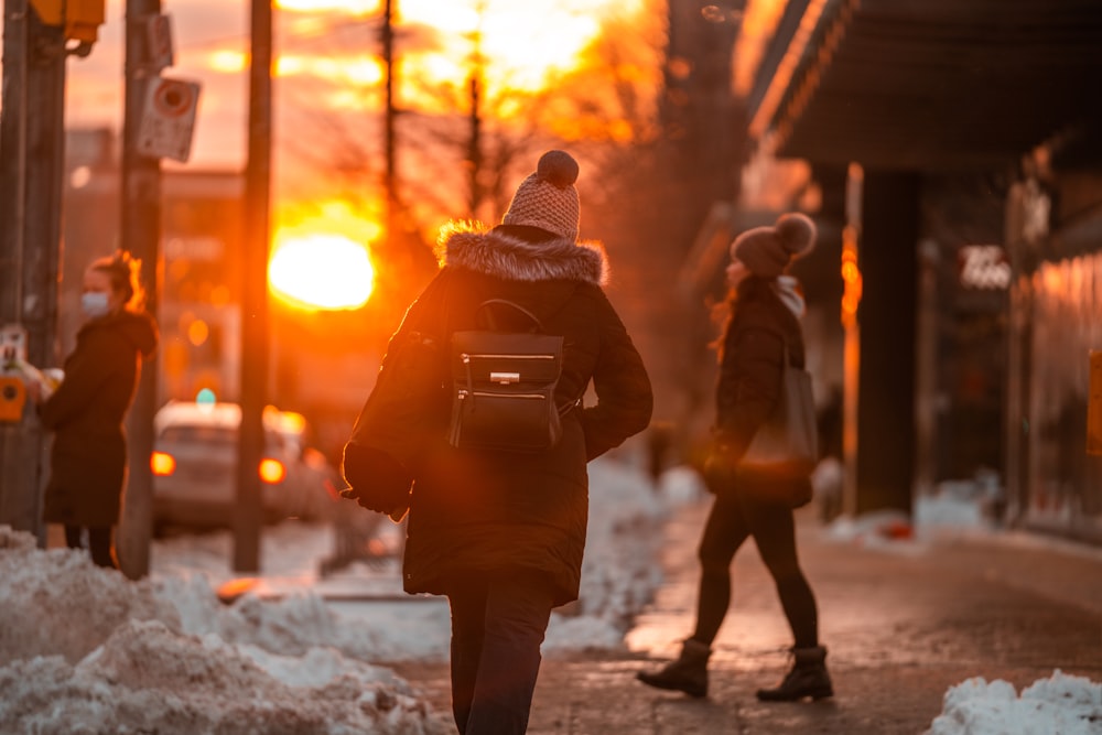 a person walking down a street in the snow