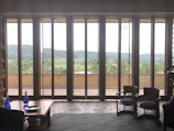 Valley room featuring traditional wood furniture and a window view of green hills.