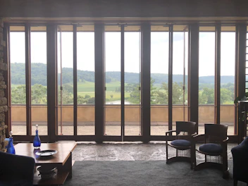 Valley room featuring traditional wood furniture and a window view of green hills.