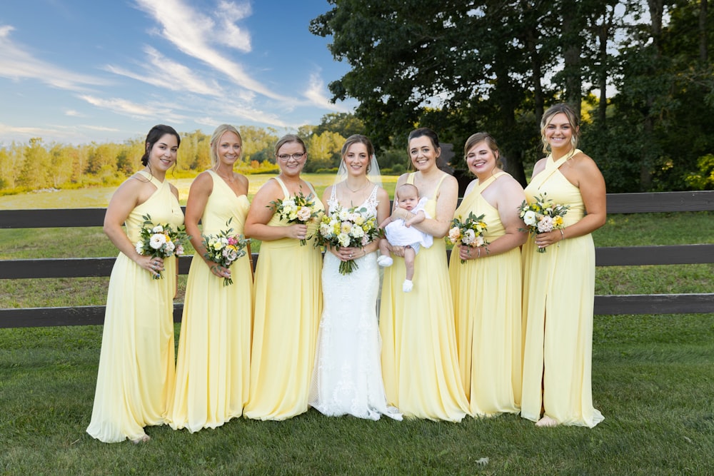 a bride and her bridesmaids in yellow dresses