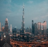 a view of a city at night from the top of a skyscraper