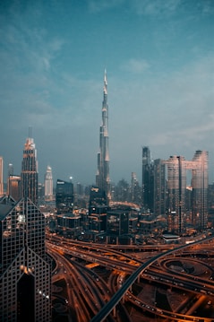 a view of a city at night from the top of a skyscraper
