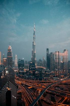 a view of a city at night from the top of a skyscraper