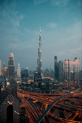 a view of a city at night from the top of a skyscraper