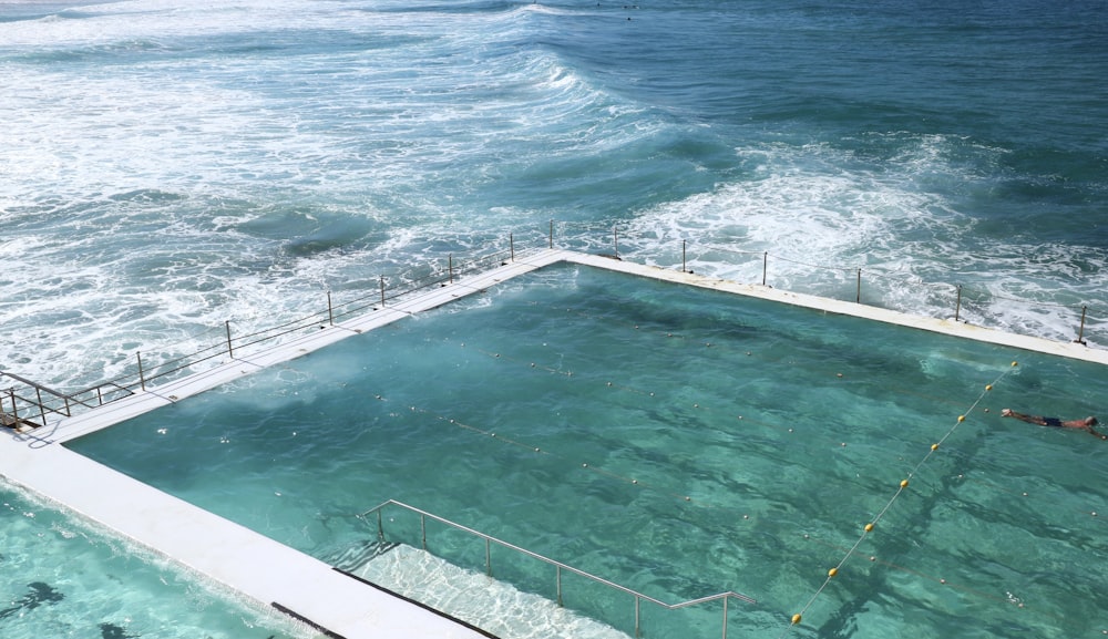 a large swimming pool in the middle of the ocean