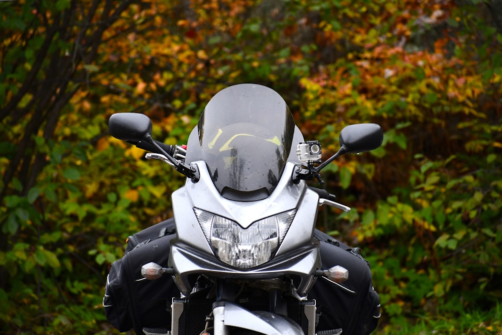 a motorcycle parked in front of some trees