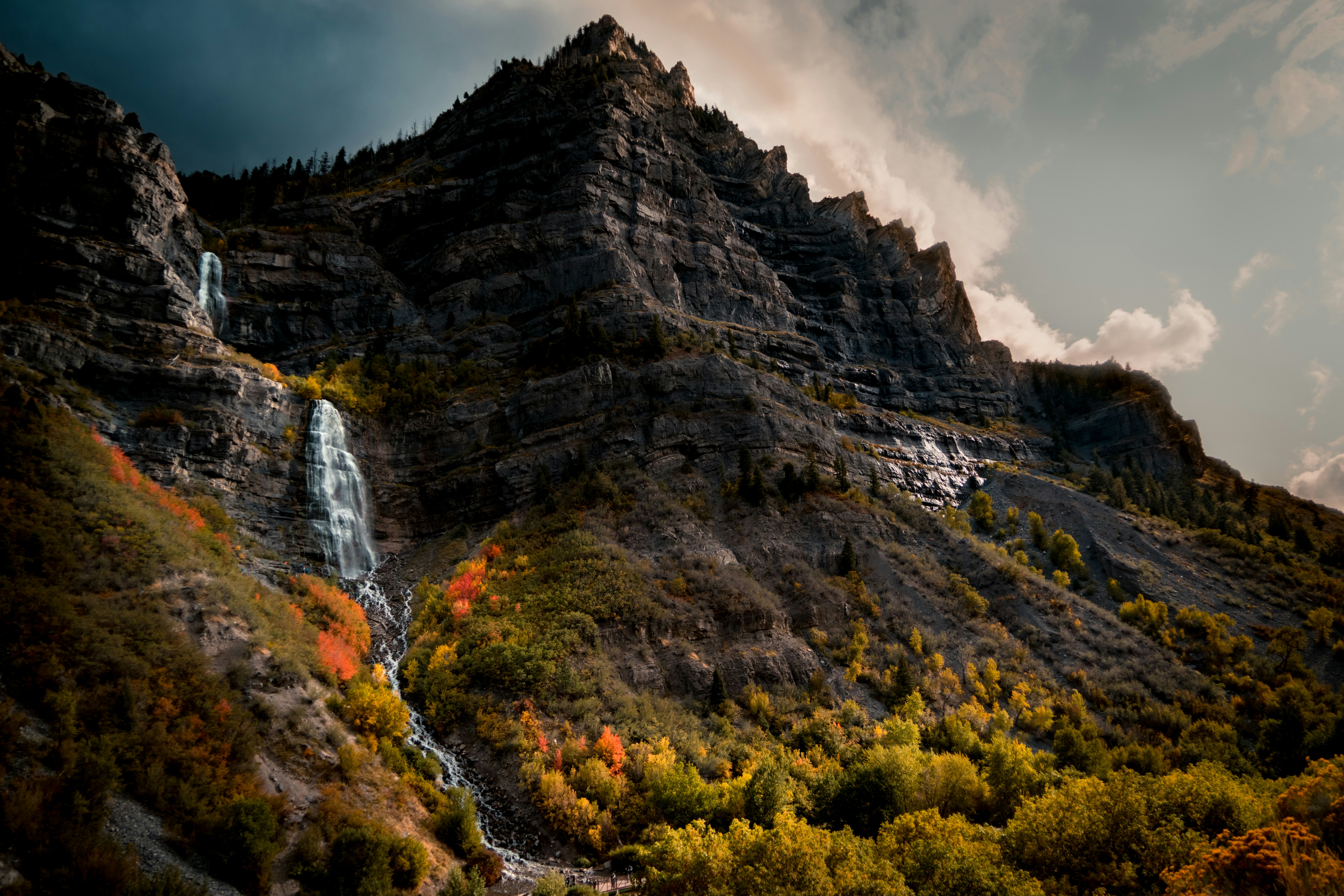 a waterfall in the middle of a mountain