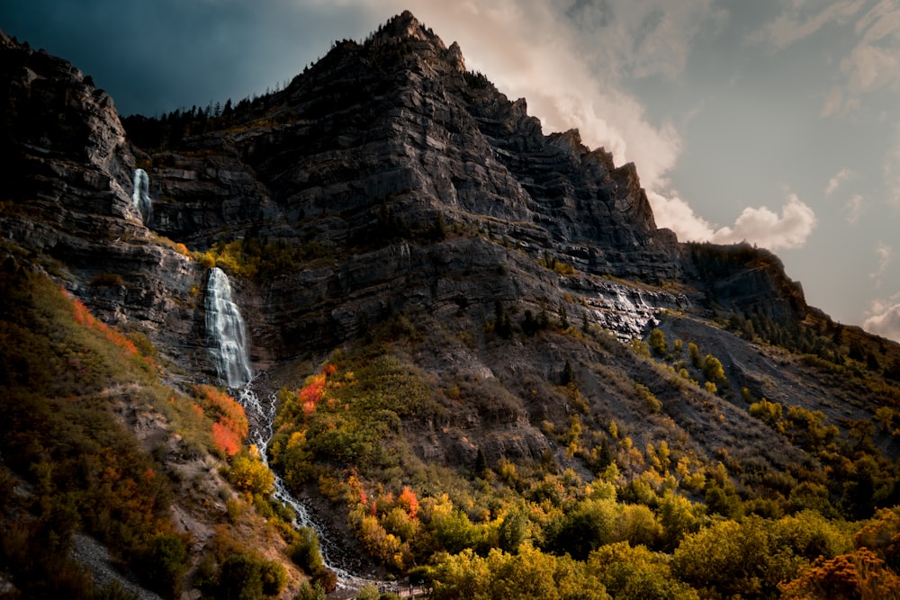 a waterfall in the middle of a mountain