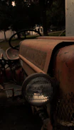 A close-up of a vintage farm tractor being carefully restored in a rustic Montana workshop.