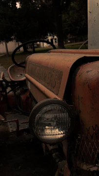 A close-up of a vintage farm tractor being carefully restored in a rustic Montana workshop.