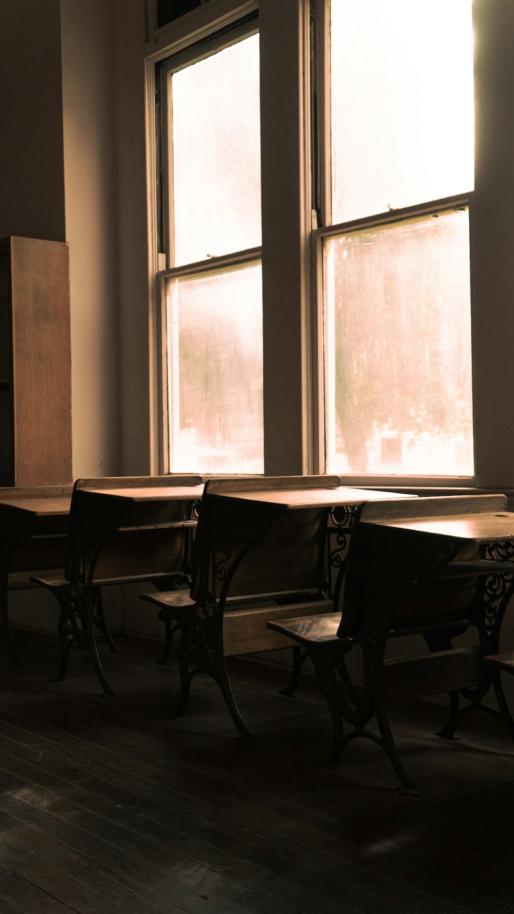 a row of desks in front of a window