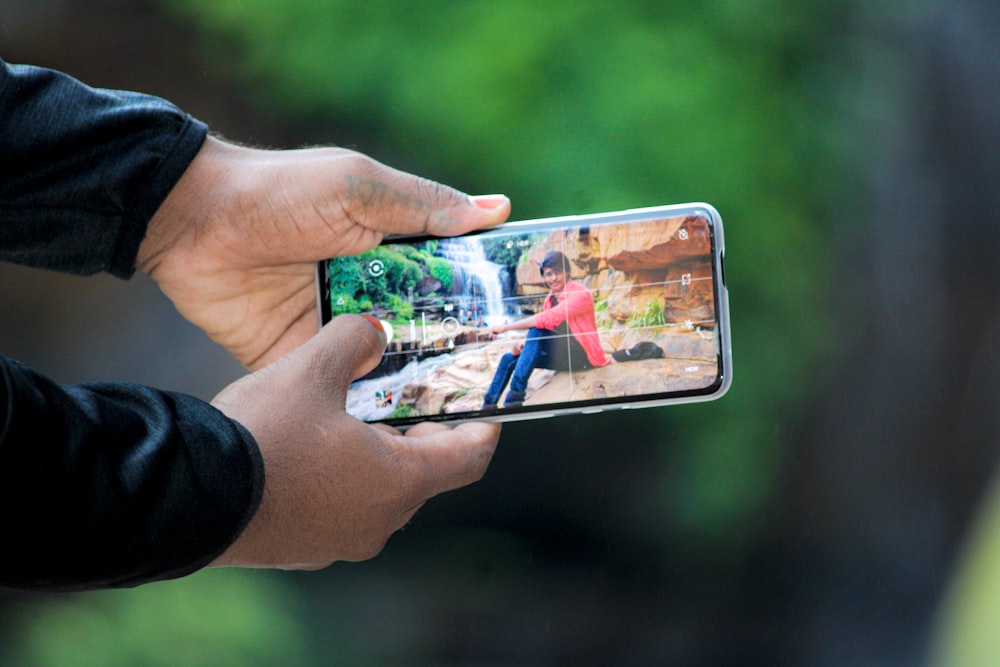 a person taking a picture with a cell phone