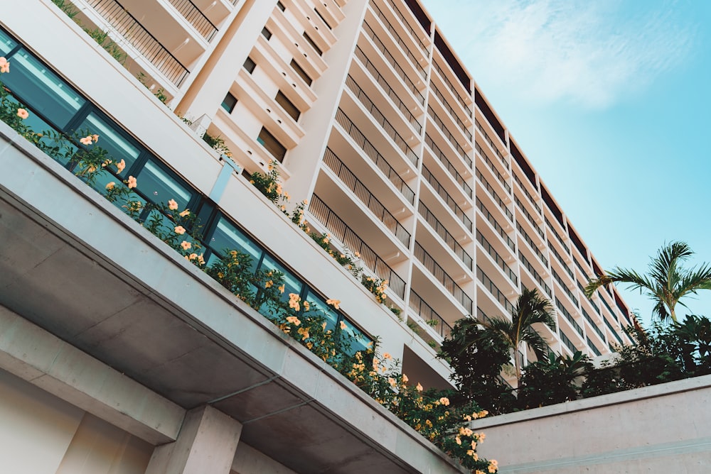 a tall building with a bunch of flowers on the balconies