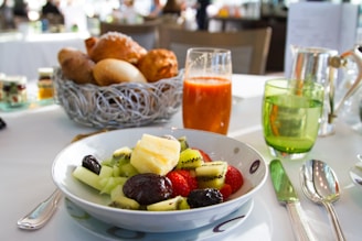 a bowl of fruit is sitting on a table