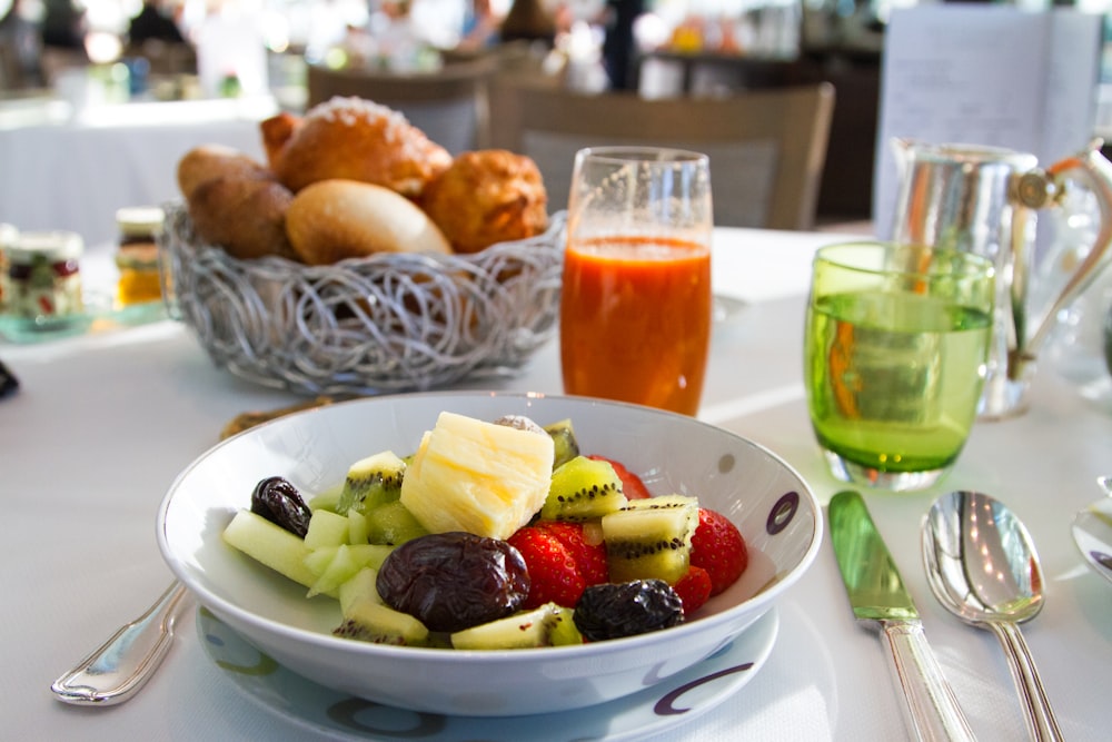 a bowl of fruit is sitting on a table