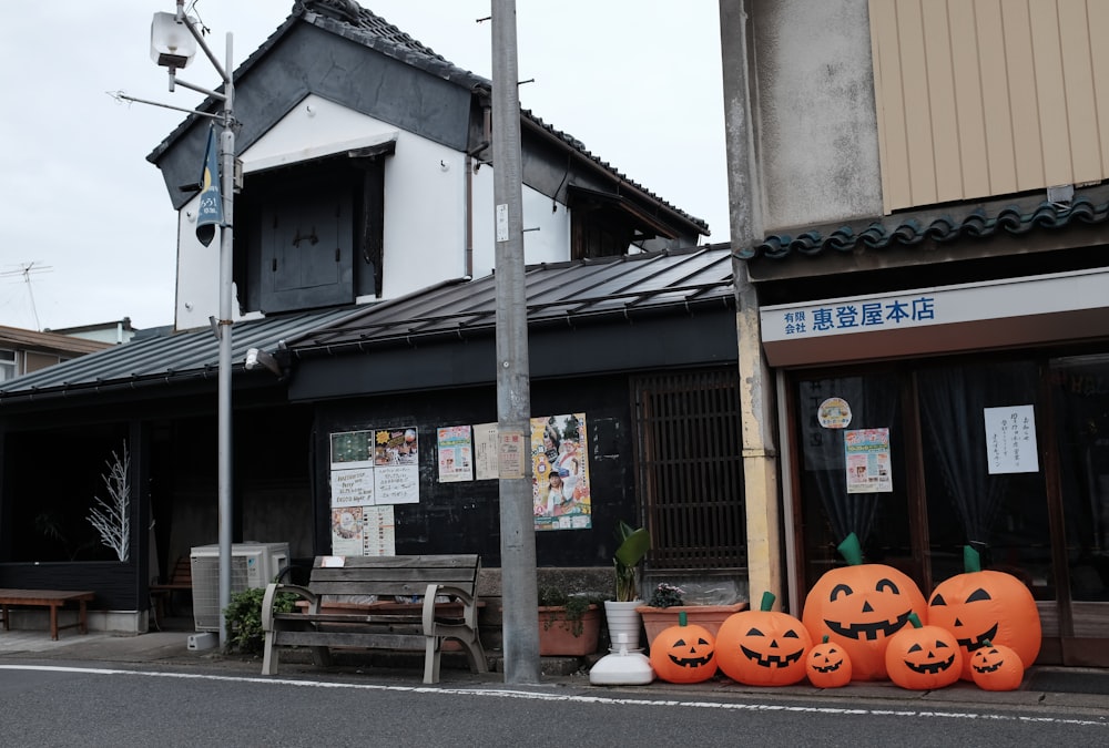 a row of pumpkins sitting on the side of a road