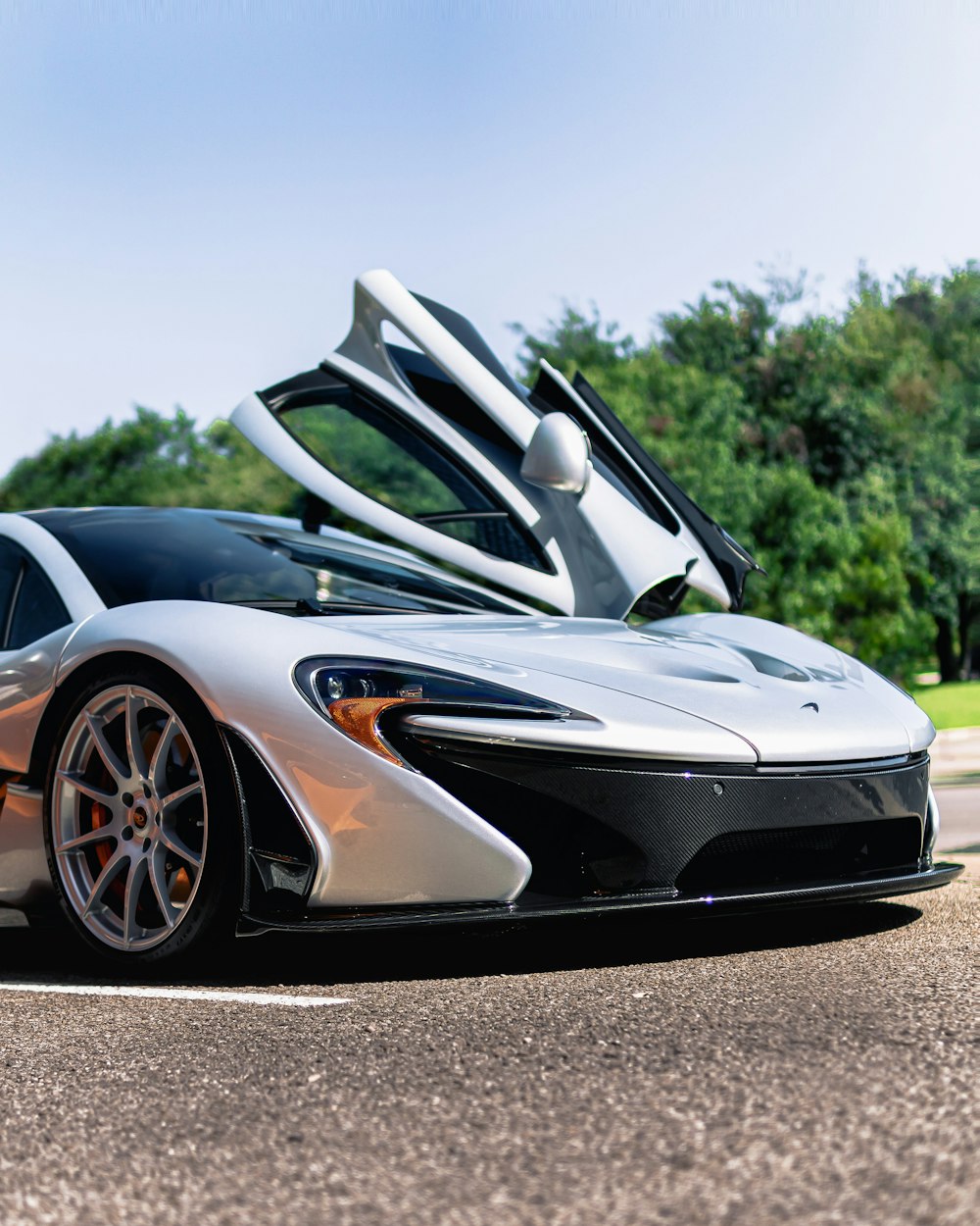 a white and black sports car parked on the side of the road