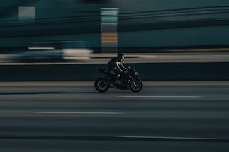 a person riding a motorcycle on a city street