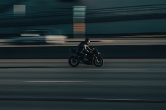 a person riding a motorcycle on a city street