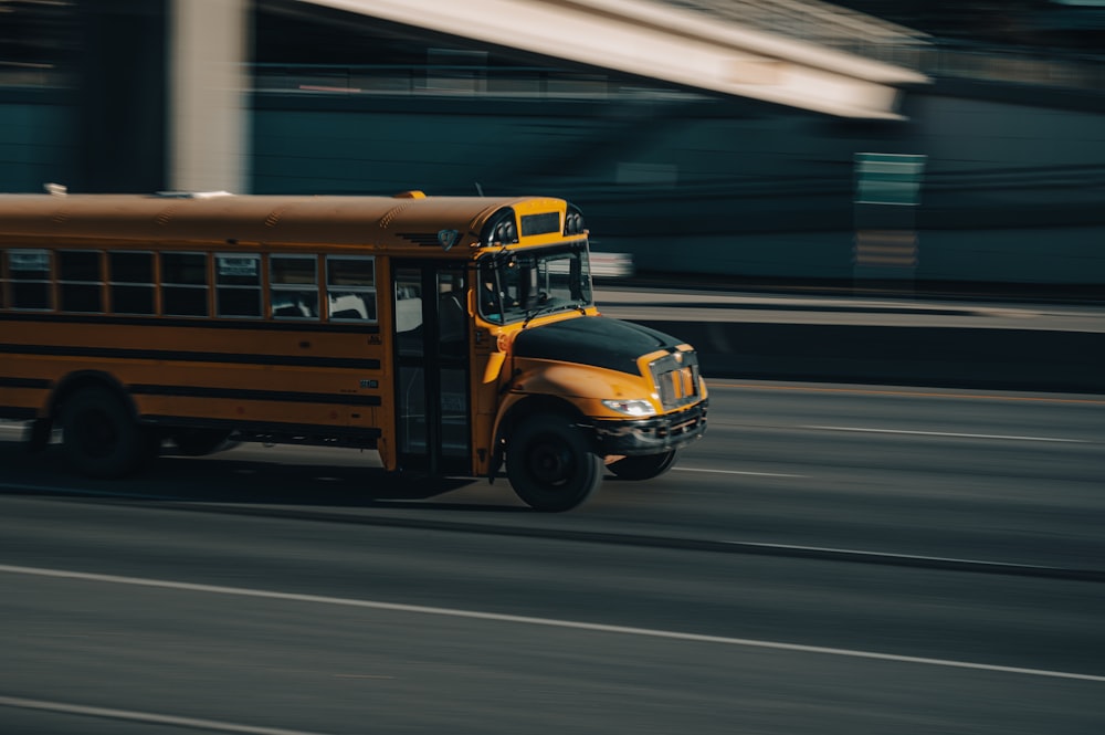 a yellow school bus driving down a street