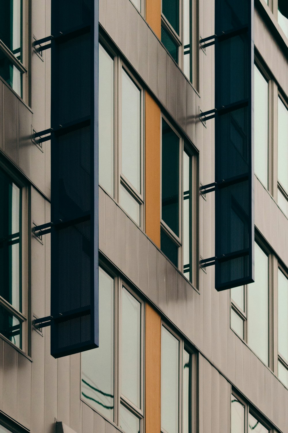 a tall building with lots of windows next to a traffic light