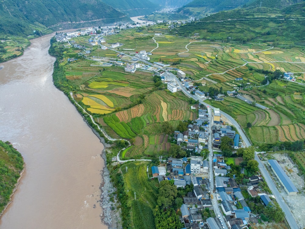 an aerial view of a village and river