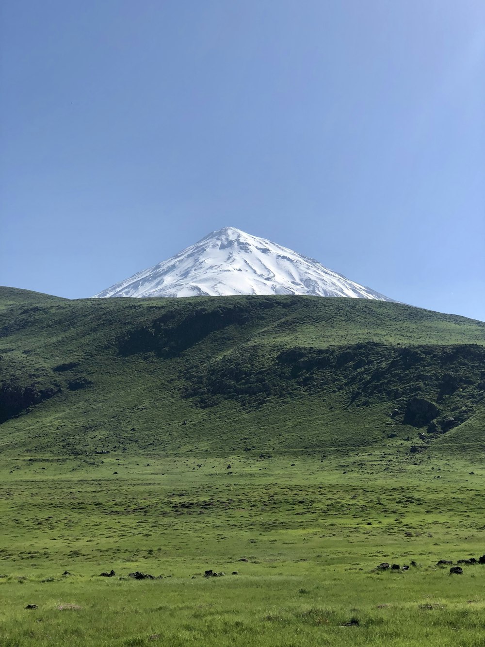 a mountain with a snow capped peak in the distance