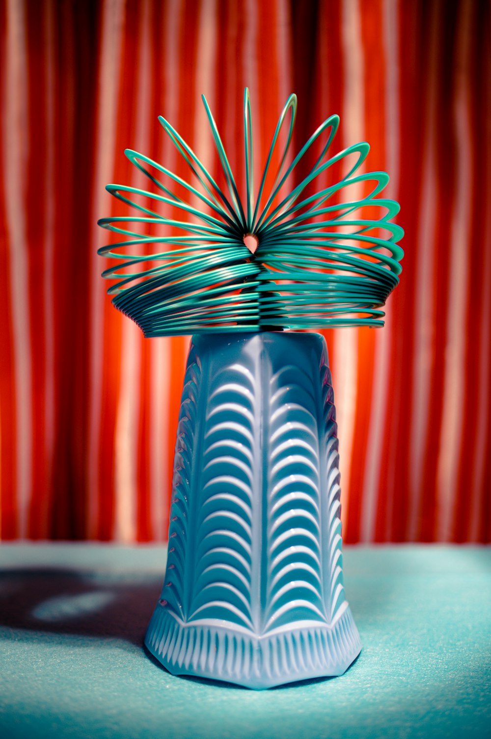 a blue vase sitting on top of a blue table