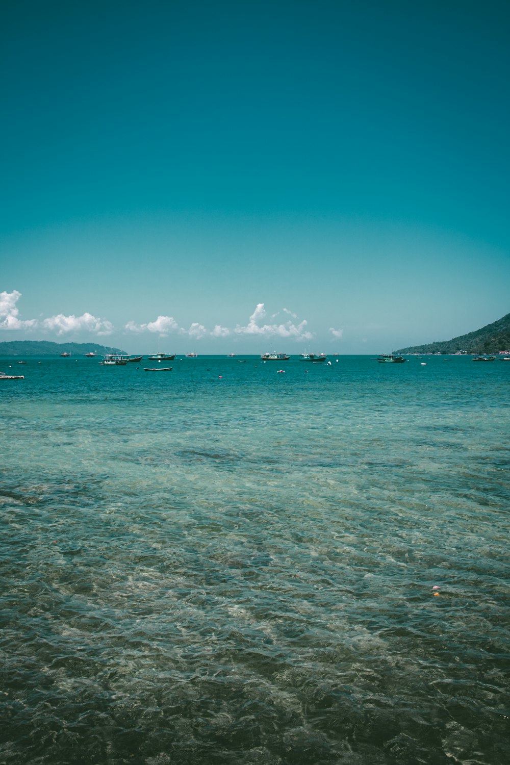 a body of water with boats in the distance