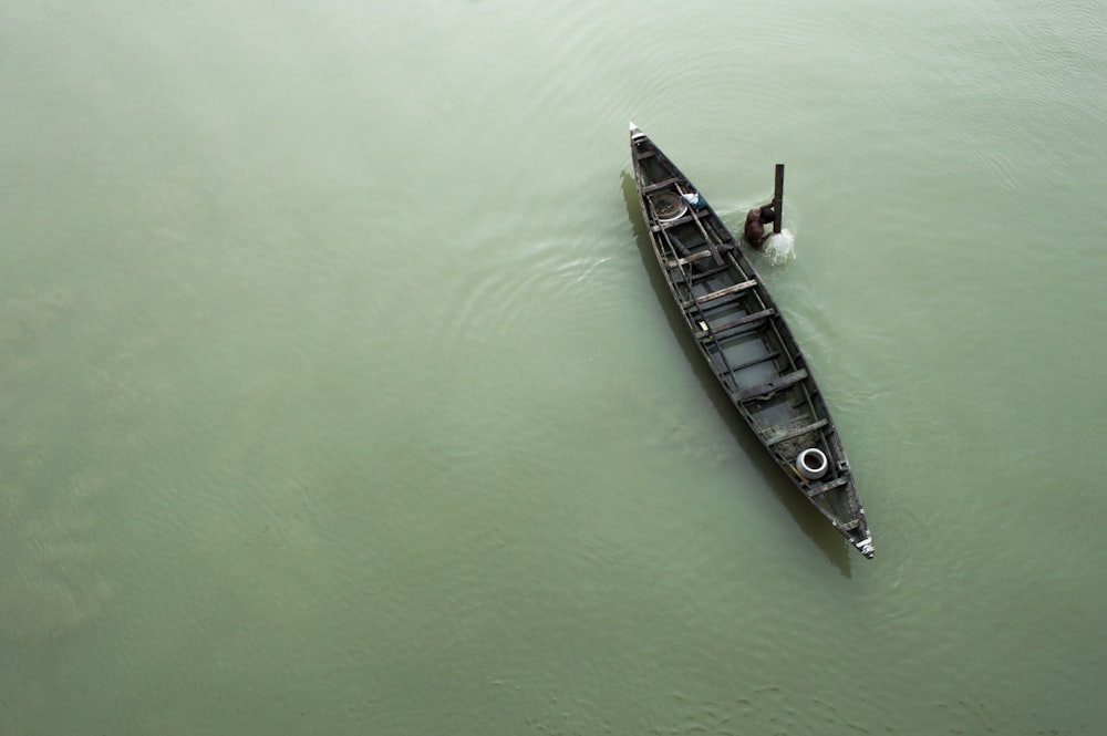 a small boat floating on top of a body of water