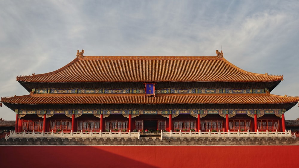 a large building with a red wall and a red wall below it