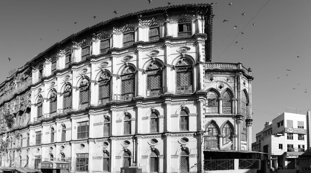 a large building with birds flying around it