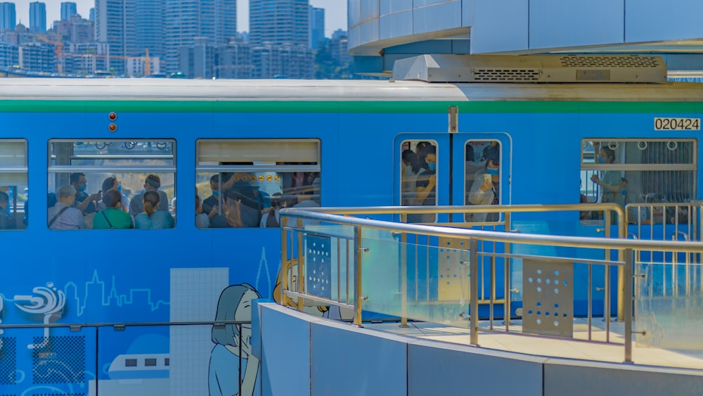 a blue train with a lot of people on it