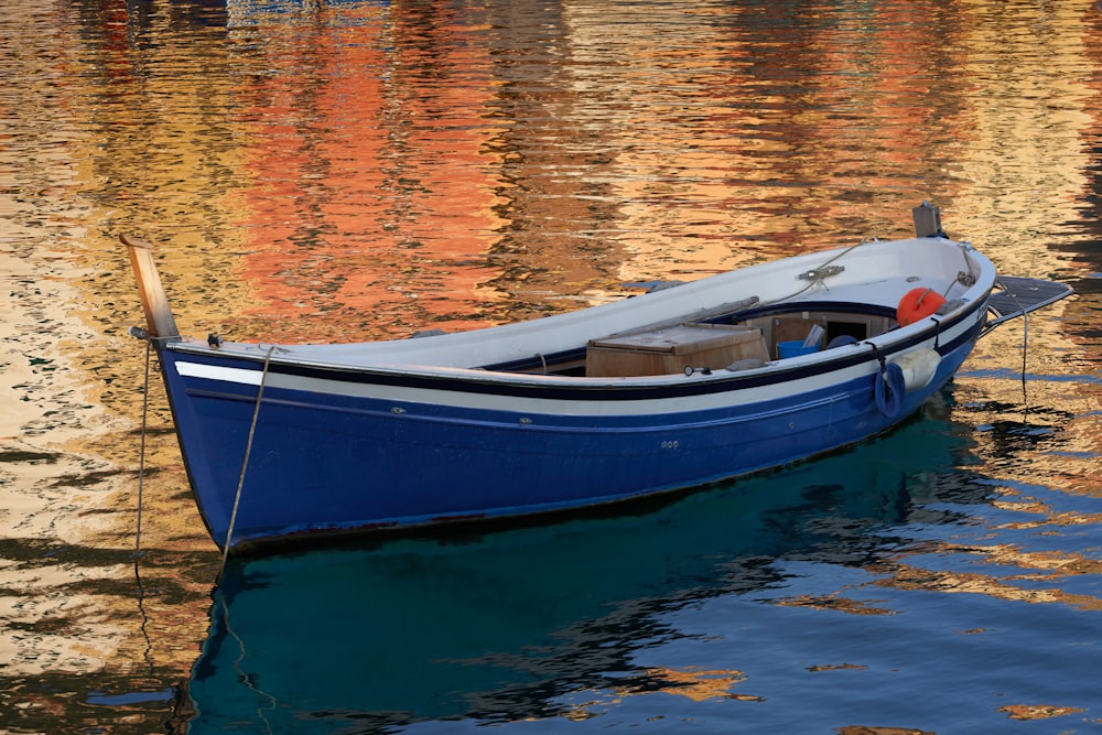 a small boat floating on top of a body of water