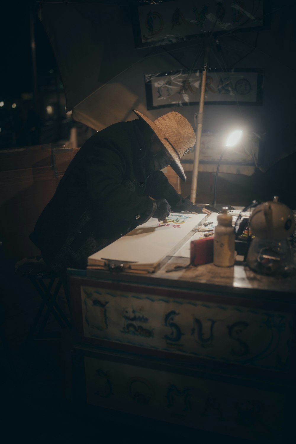 a person sitting at a desk in a dark room