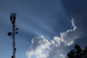 An outdoor image of a telecommunications tower against a clear blue sky, symbolizing reliable connectivity.