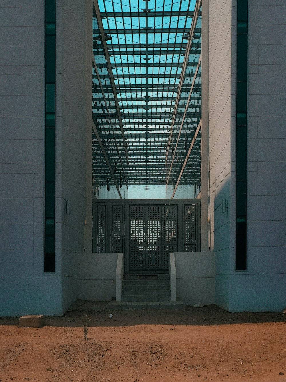 a white building with a blue skylight above it